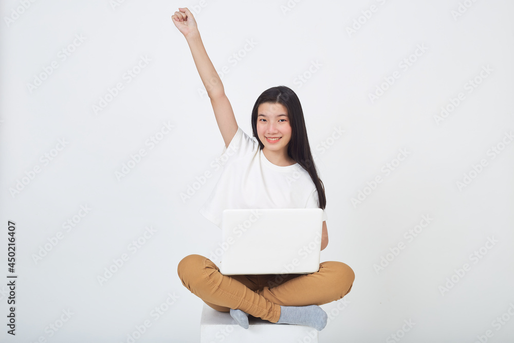 woman sitting using laptop sitting on gray background woman sitting using laptop sitting on gray background
