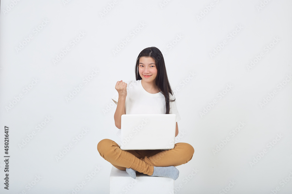 woman sitting using laptop sitting on gray background woman sitting using laptop sitting on gray background
