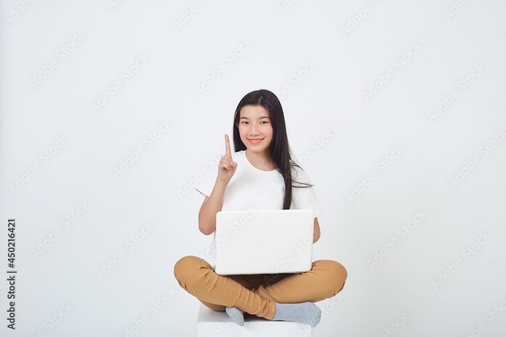 woman sitting using laptop sitting on gray background woman sitting using laptop sitting on gray background