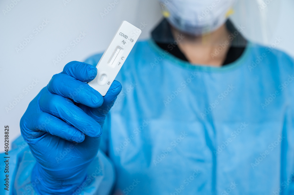 Healthcare worker holding a rapid antigen test kit before using it. Rapid antigen testing is a screening tool to help detect COVID-19 in people without any symptoms of COVID-19. Healthcare worker holding a rapid antigen test kit before using it. Rapid antigen testing is a screening tool to help detect COVID-19 in people without any symptoms of COVID-19.
