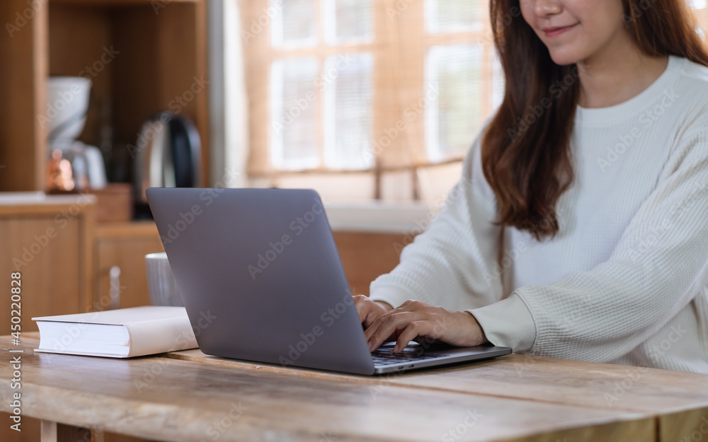 Closeup image of a beautiful young asian woman freelancer using laptop computer for working online at home Closeup image of a beautiful young asian woman freelancer using laptop computer for working online at home