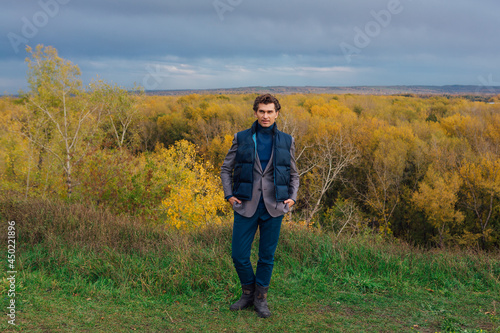 Tall handsome man outdoor in autumn forest on the hill © Smile