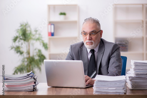 Wallpaper Mural Old male employee working in the office Torontodigital.ca