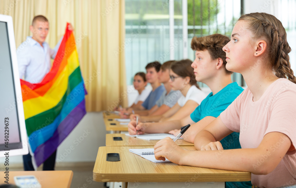 Pupils in classroom listen to the teacher who explains what is LGBT