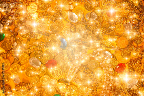 pile of golden coins gems jewel and diamond treasure with blink glitter for background. photo