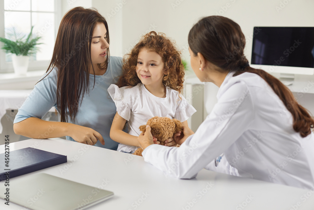 Mother and child seeing family doctor. Mum and kid talking to friendly
