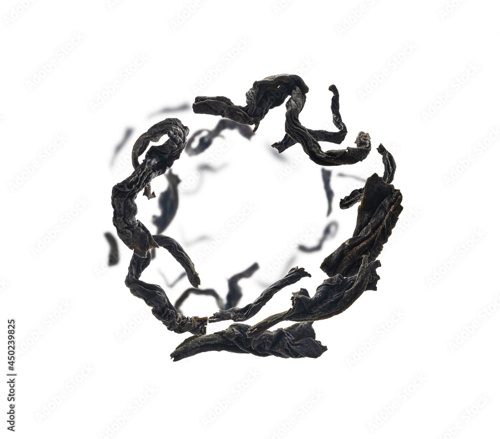 Dried black tea close up levitating on white background Dried black tea close up levitating on white background