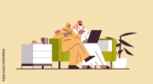 arab couple with credit card using laptop online shopping concept man woman ordering goods together
