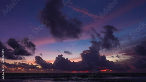 .colorful light through to the cloud above the ocean..Clouds are moving slowly in stunning sunset video 4K. Nature video High quality footage .Scene of Colorful romantic sky sunset background.