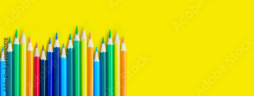 pencils on yellow background with copy space. School and creative painting concept with colored pencils. Back to school banner.