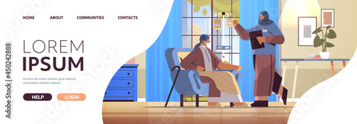 friendly arab nurse or volunteer checking dripper of elderly man patient home care services healthcare