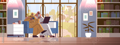 arab couple with credit card using laptop online shopping concept man woman ordering goods together