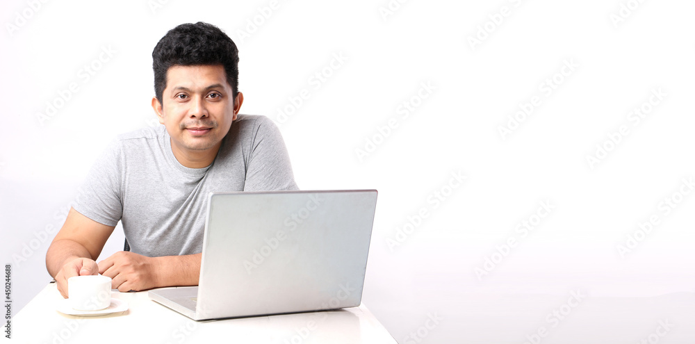 Asian man That has The computer page in front of. on white background in studio With copy space.