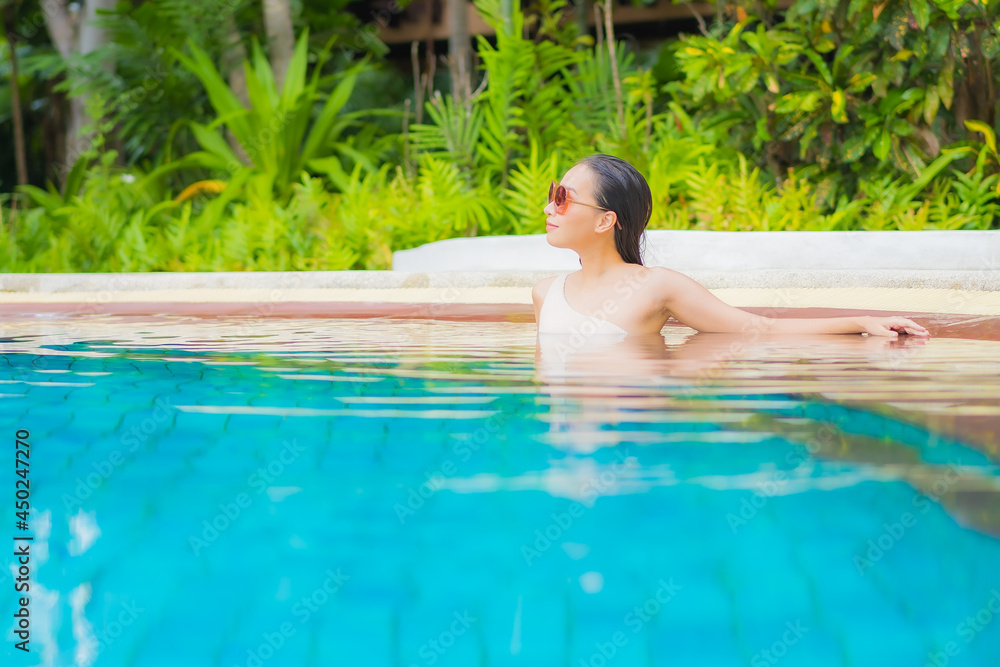 Portrait beautiful young asian woman relax around outdoor swimming pool