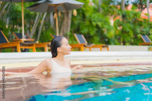 Portrait beautiful young asian woman relax around outdoor swimming pool