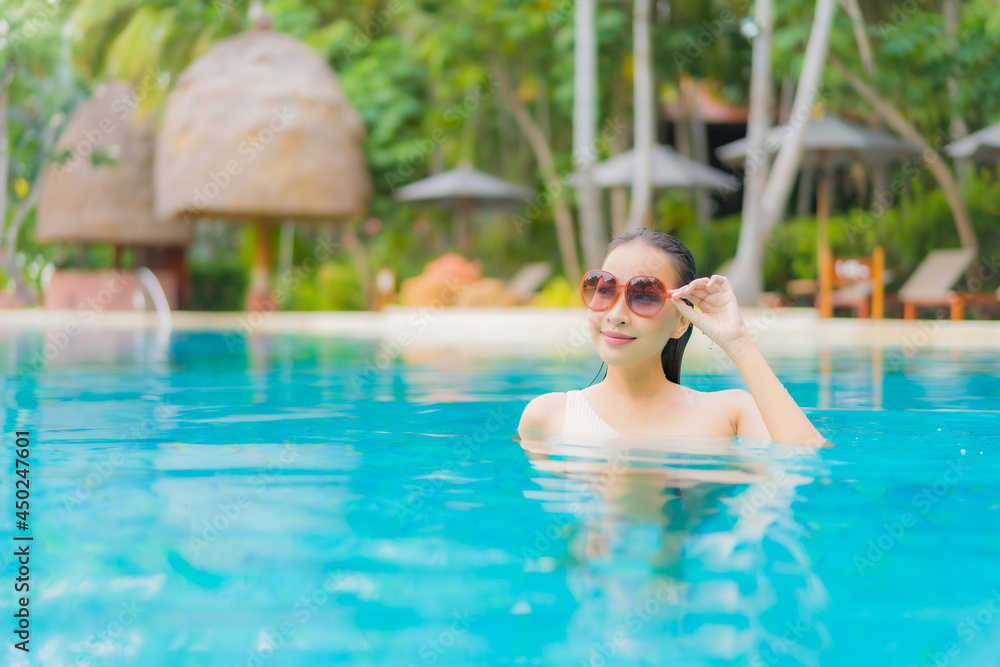 Portrait beautiful young asian woman relax around outdoor swimming pool