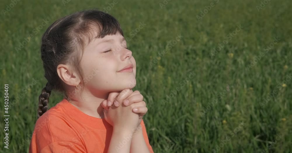 Happy childhood with praying. A smiling child pray and dream for something in the heart of the nature. Happy childhood with praying. A smiling child pray and dream for something in the heart of the nature.
