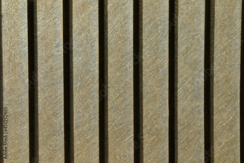 Metal bars silhouetted against a backlit fiberglass plastic background 