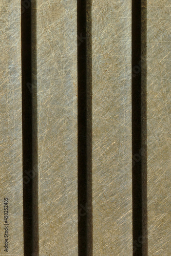 Metal bars silhouetted against a backlit fiberglass plastic background 