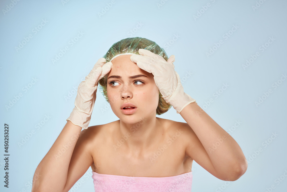 woman with bare shoulders squeezes out gloved pimples shower cap woman with bare shoulders squeezes out gloved pimples shower cap