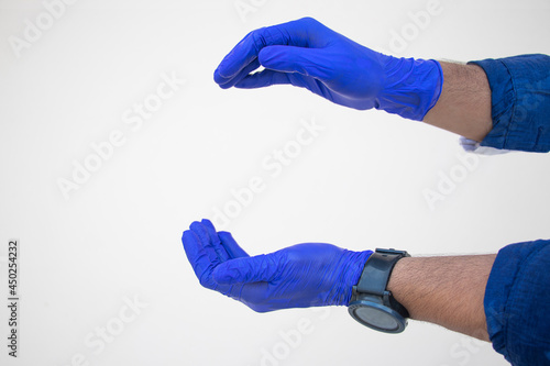 Human hands in medical gloves showing sign