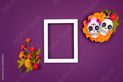 Day of the dead, Dia De Los Muertos, halloween Celebration Background. Sugar Skull calaverita marigolds empty frame, purple Copy Space. Traditional Mexican culture festival flyer. Flat lay, top view photo