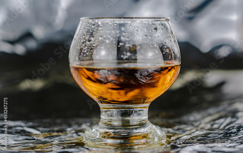 Glass of whisky on the table photo