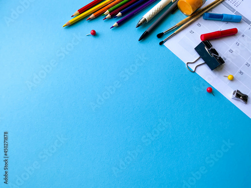 School supplies on colorful background, top view. Creative frame layout with school stationery. Flat lay. Colored stationery. Isolated background.  Copy space.  Back to school. Banner