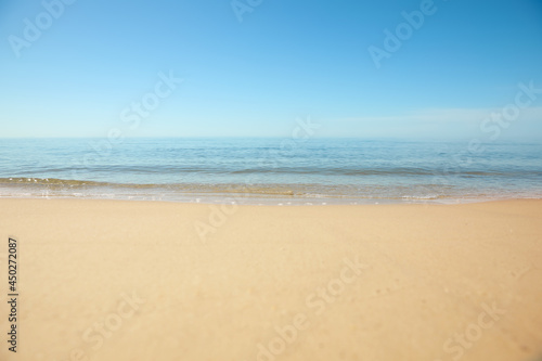 Beautiful sandy beach and sea under blue sky, closeup © New Africa