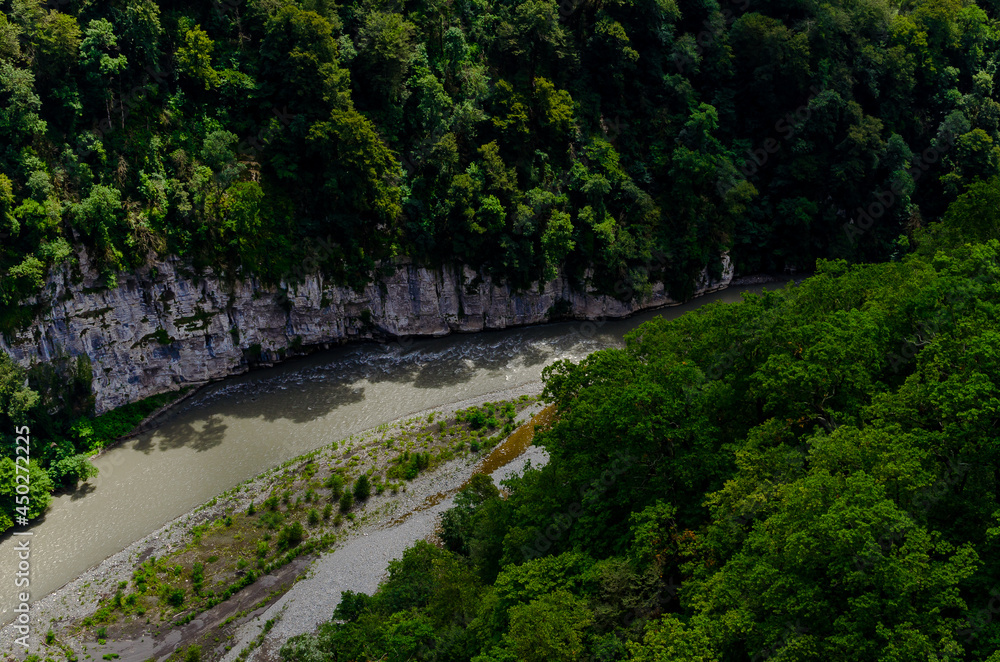 road near the river top view among the mountains with plants in summer from bridge Skypark AJ Hacket Sochi