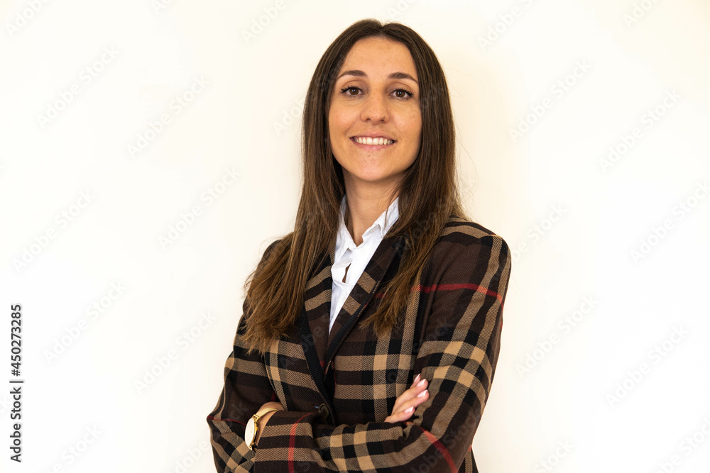 Photo of a young and attractive woman looking corporative with a shirt smiling at the camera, looking professional and ready to do bussiness with a white background