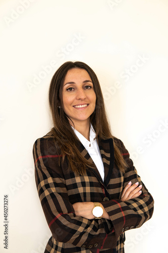 Obraz na płótnie Photo of a young and attractive woman looking corporative with a shirt smiling at the camera, looking professional and ready to do bussiness with a white background w salonie