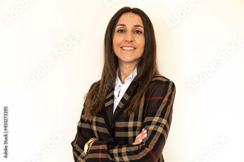 Obraz na płótnie Photo of a young and attractive woman looking corporative with a shirt smiling at the camera, looking professional and ready to do bussiness with a white background w salonie