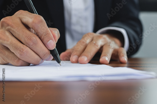 Closeup hand manager signature on document, Sign contact business in office concept