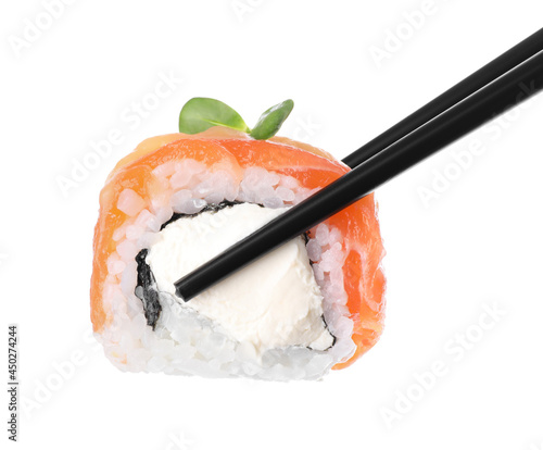 Holding sushi roll with chopsticks on white background, closeup