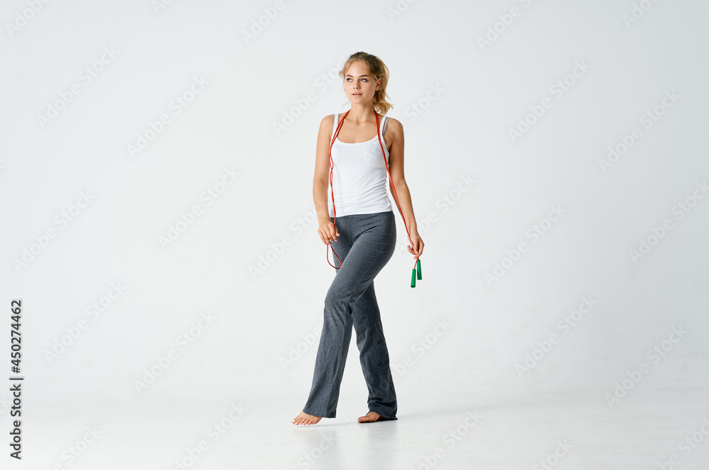sportive woman doing fitness skipping rope in hands energy motivation