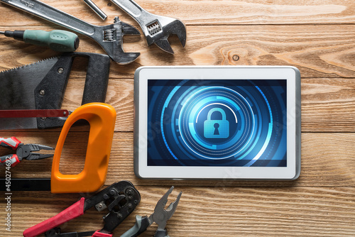 Web security and technology concept with tablet pc on wooden table