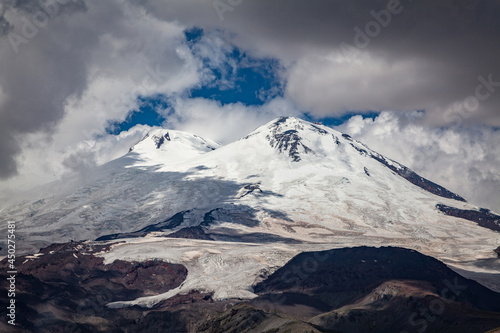 view of the snowy peaks of Mount Elbrus in the cloudy sky