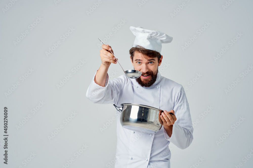 male chef with a saucepan in his hands professional work kitchen lifestyle male chef with a saucepan in his hands professional work kitchen lifestyle