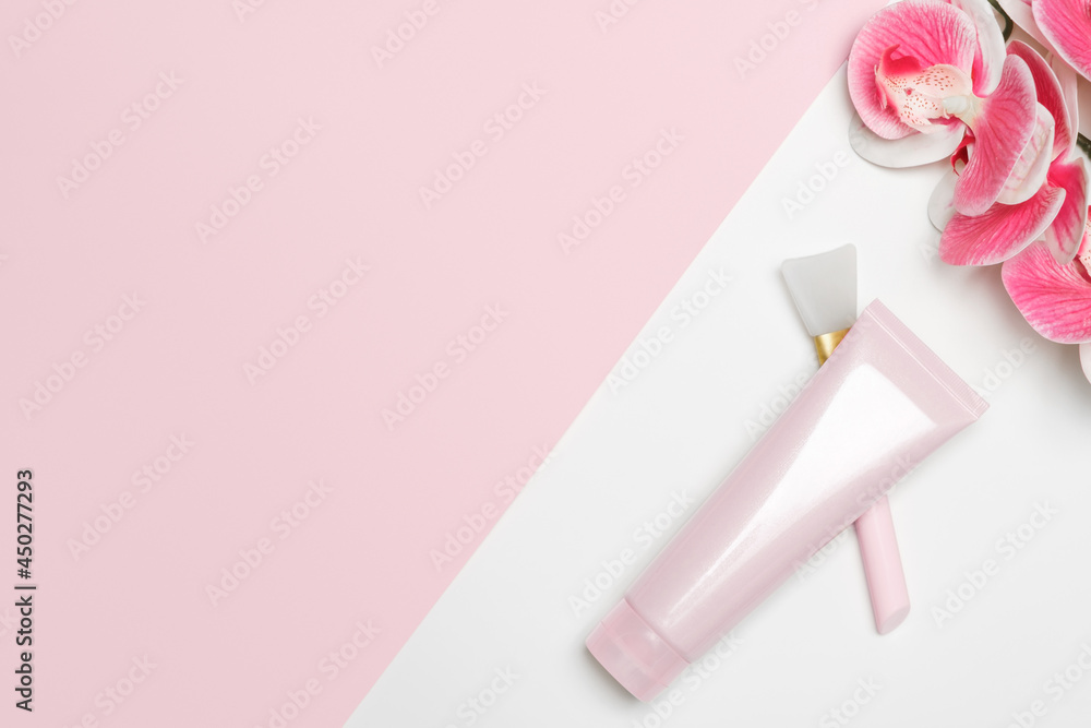 Cosmetic face mask on a light background with an orchid. Tube and application tool. Cosmetic face mask on a light background with an orchid. Tube and application tool.