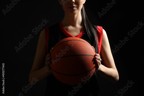 Basketball player with ball on black background, closeup © New Africa