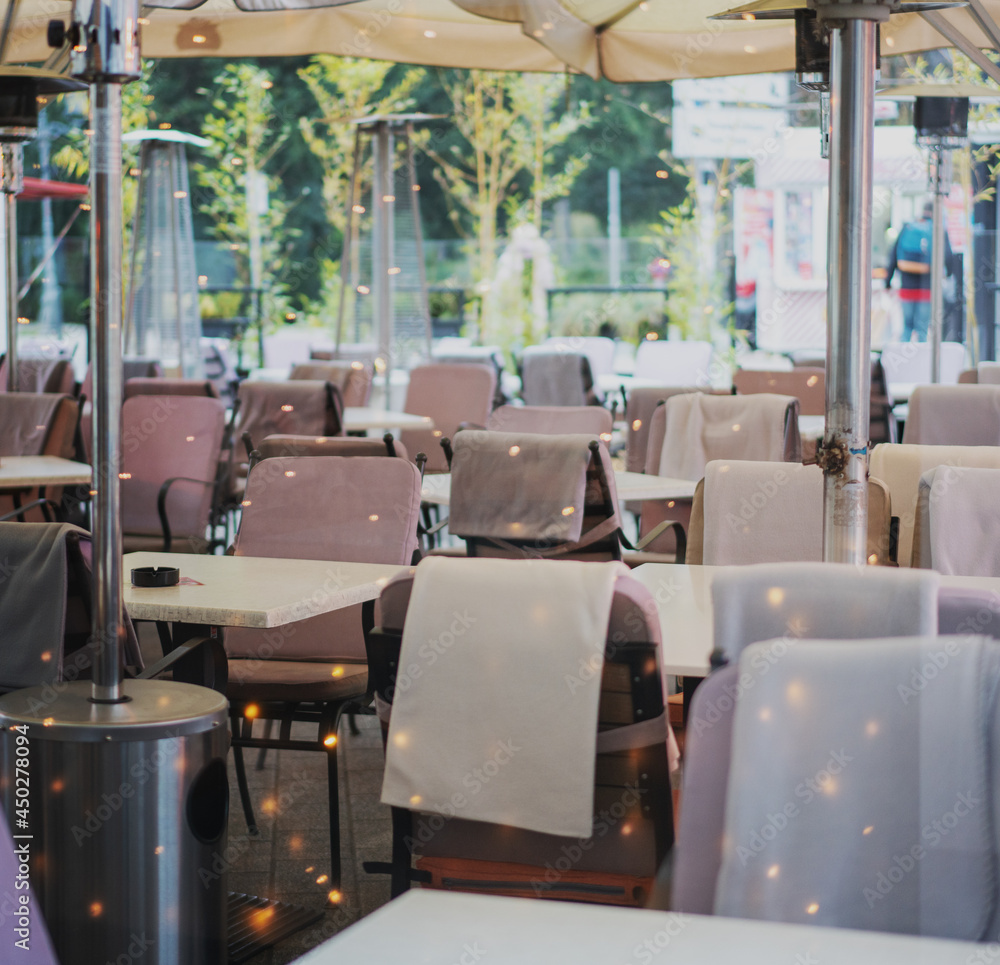 Empty street cafe in European city with blankets on chairs Empty street cafe in European city with blankets on chairs