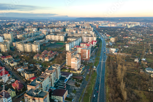 High rise apartment buildings and streets with traffic in city residential area. © bilanol