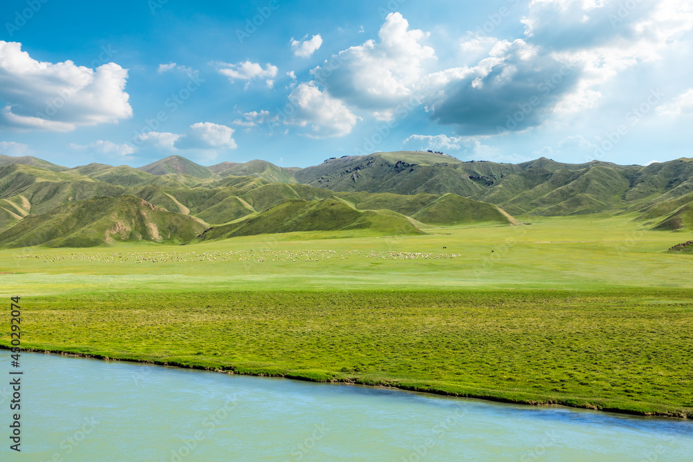 Grassland and river with mountain natural landscape in Xinjiang.