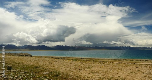 4k time lapse of huge clouds mass rolling over lake namtso & Tanggula snow mountain peak,tibet mansarovar,Tibet's second largest lake,is the third largest saltwater lake in China.Danggula(Tanggula) Mo photo