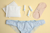 Tampons and other menstrual hygienic products on yellow background, flat lay