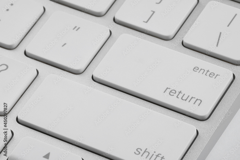 Closeup view of Enter key on modern computer keyboard Closeup view of Enter key on modern computer keyboard