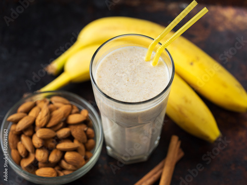 Milk smoothie cocktail for breakfast with banana, almonds and cinnamon