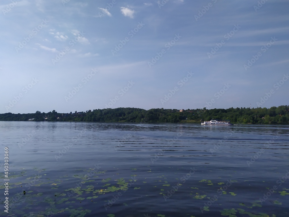 view from Russian Plyos on Volga river boat in sunny summer day with blue sky and some clouds
