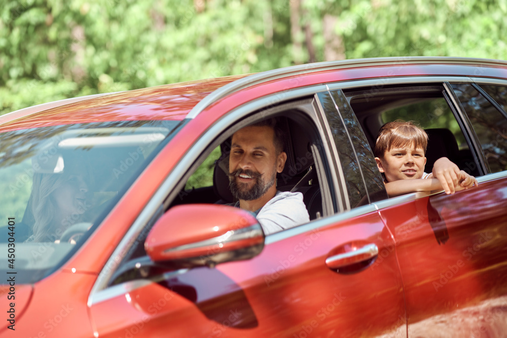Happy family during summer trip driving by car Happy family during summer trip driving by car